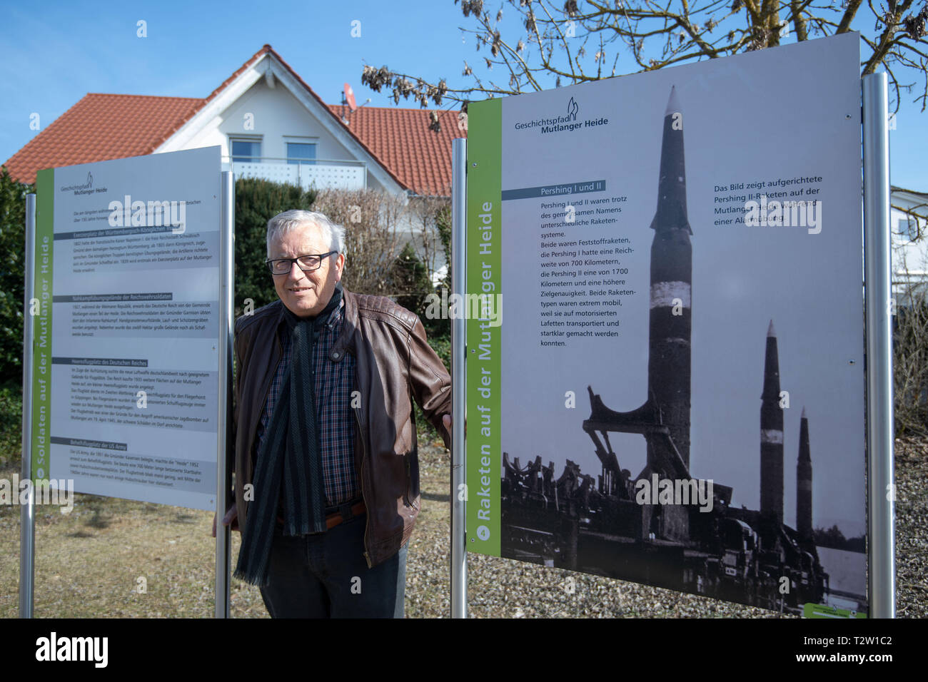 Mutlangen, Germany. 28th Feb, 2019. Peter Seyfried, former mayor of Mutlangen, stands in the residential area Mutlanger Heide between signs of the history trail Mutlanger Heide. Before being converted into a residential area, the site served as a missile base on which US medium-range nuclear missiles of the Pershing II type were stationed. (to dpa: 'No, no, Njet' - The Eastern Alb sends peace signals again) Credit: Marijan Murat/dpa/Alamy Live News Stock Photo