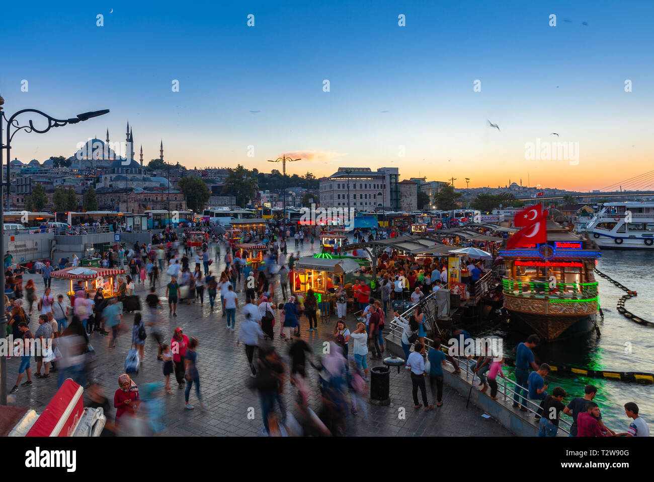 Istanbul, Turkey - August 14, 2018: People eat and walk at the Eminonu Square at dusk on August 14, 2018 in Istanbul, Turkey Stock Photo