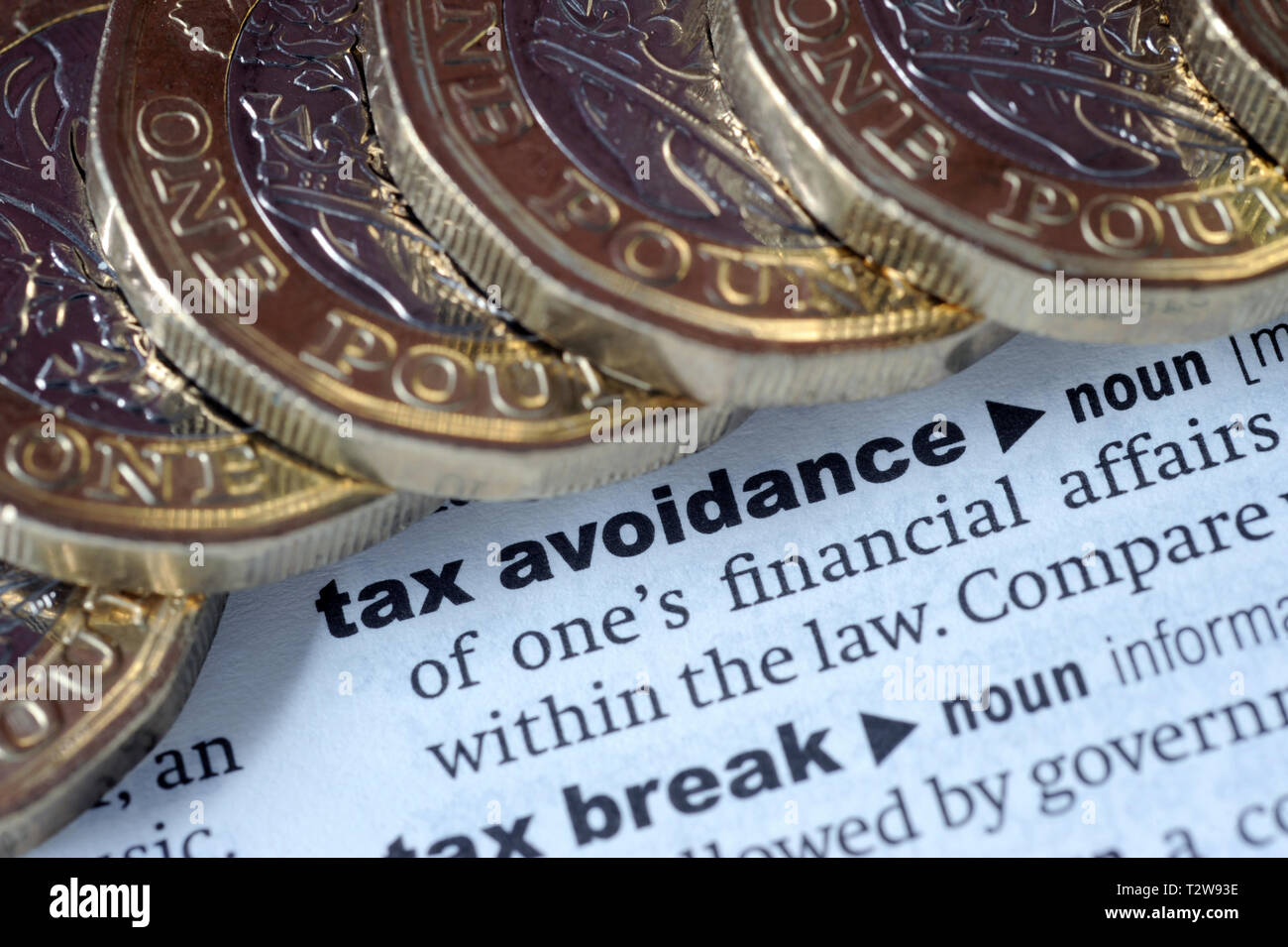 DICTIONARY DEFINITION OF TAX AVOIDANCE WITH ONE POUND COINS RE PENSIONS TAX HMRC ETC UK Stock Photo