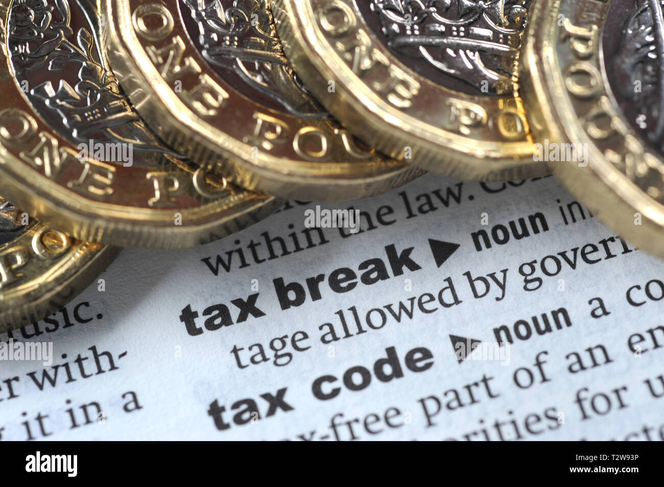 DICTIONARY DEFINITION OF TAX BREAK WITH ONE POUND COINS RE PENSIONS TAX HMRC ETC UK Stock Photo