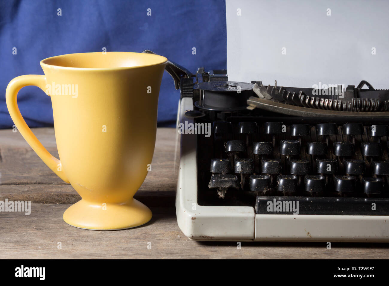 Old typewriter with coffee cup Stock Photo