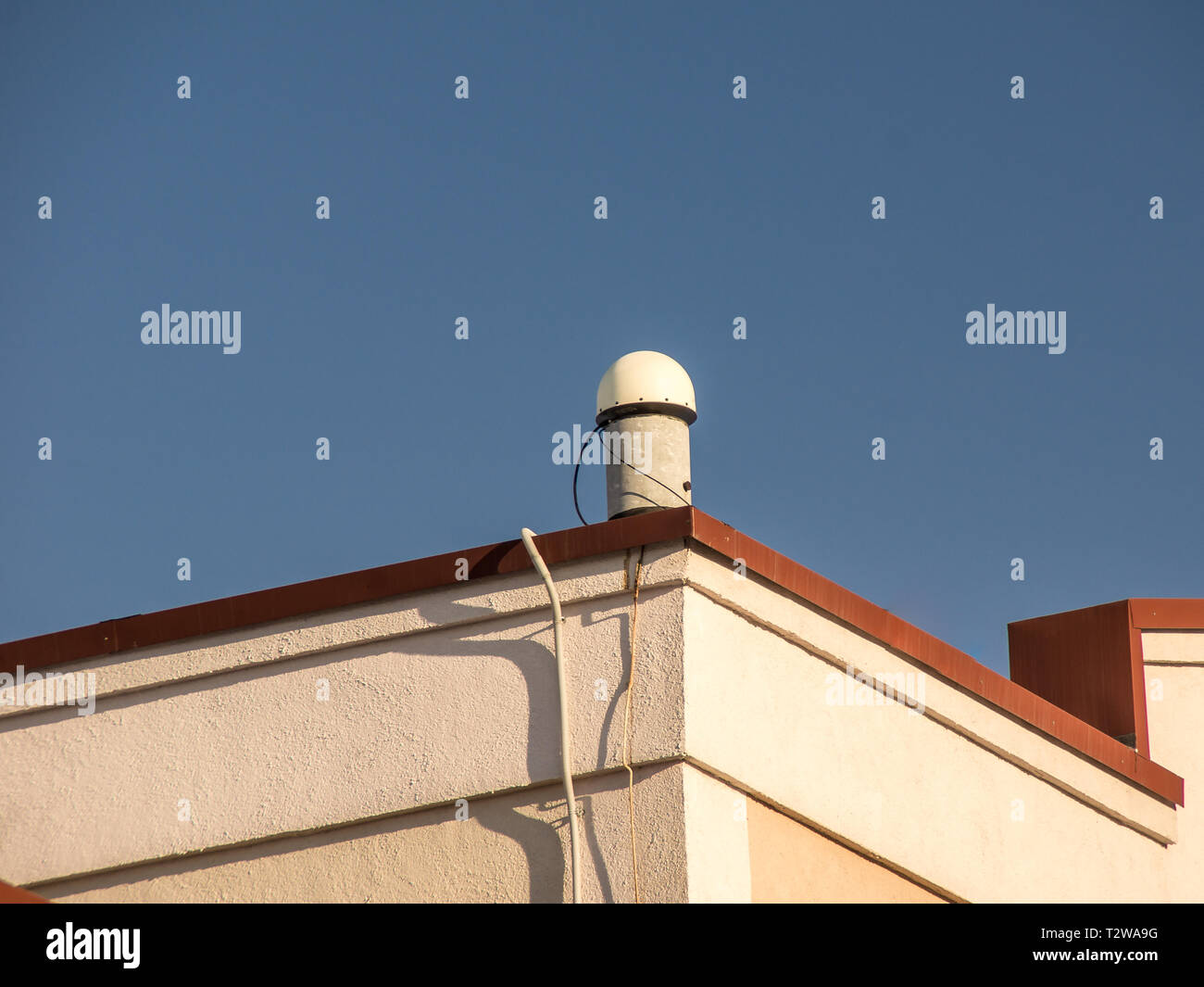 satellite surveying equipment, fixed gps base station, on the roof of a residential building Stock Photo