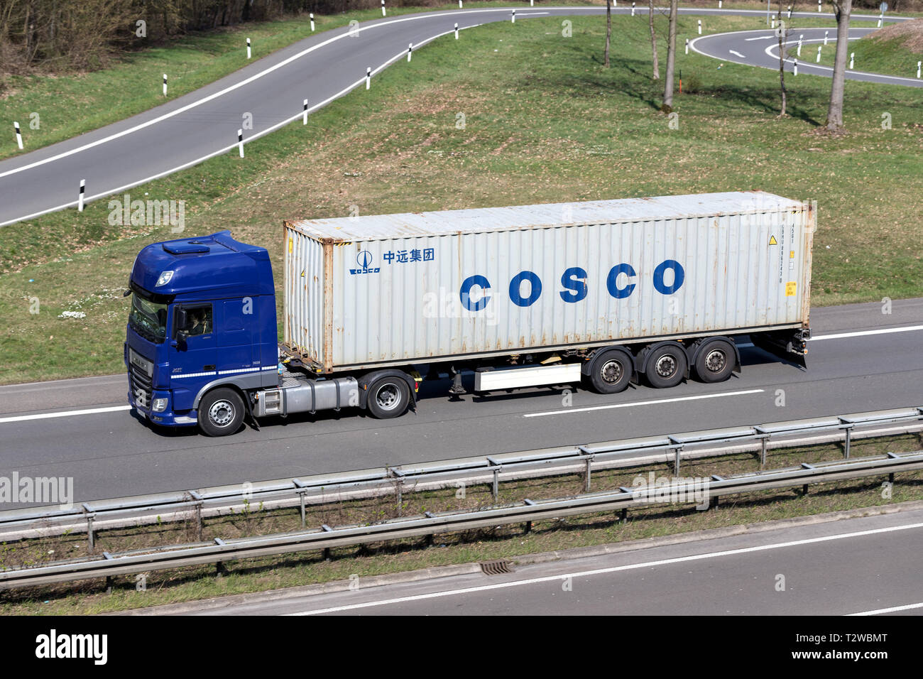 Truck with COSCO container on German motorway. Stock Photo