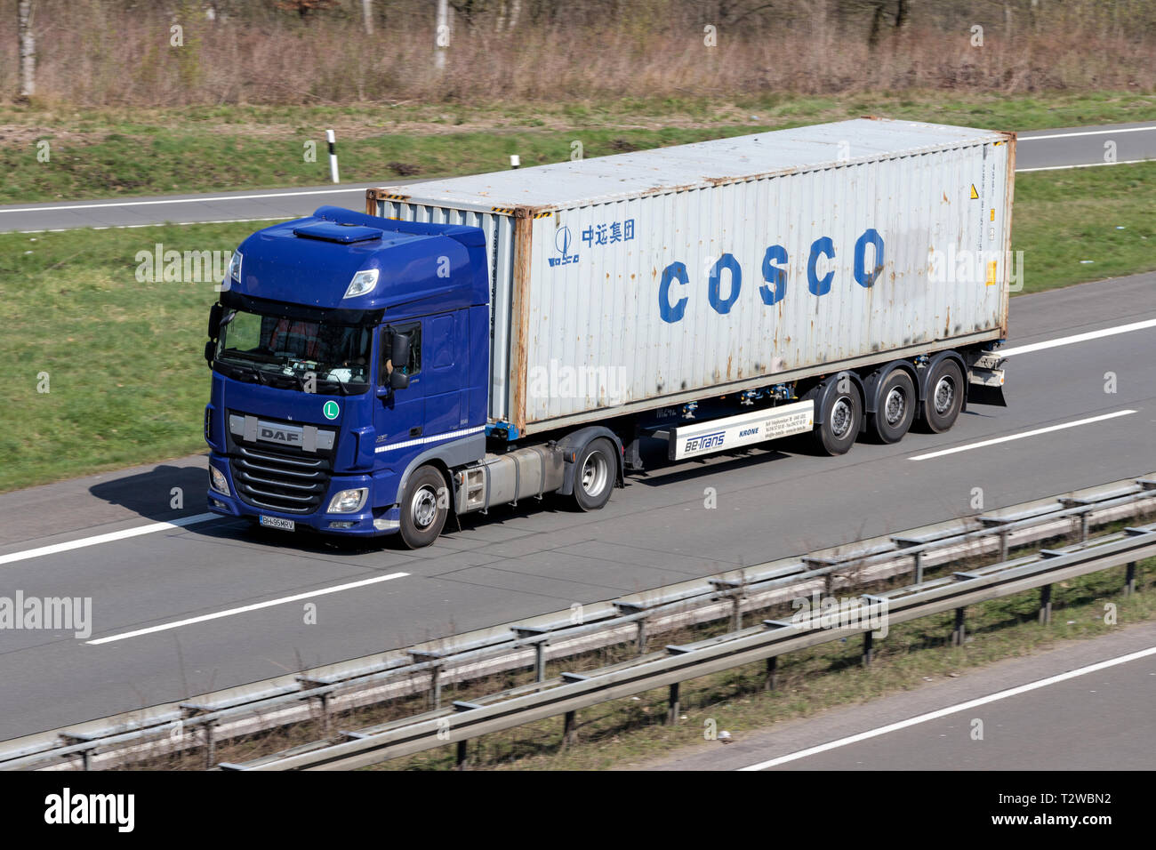 Truck with COSCO container on German motorway. Stock Photo