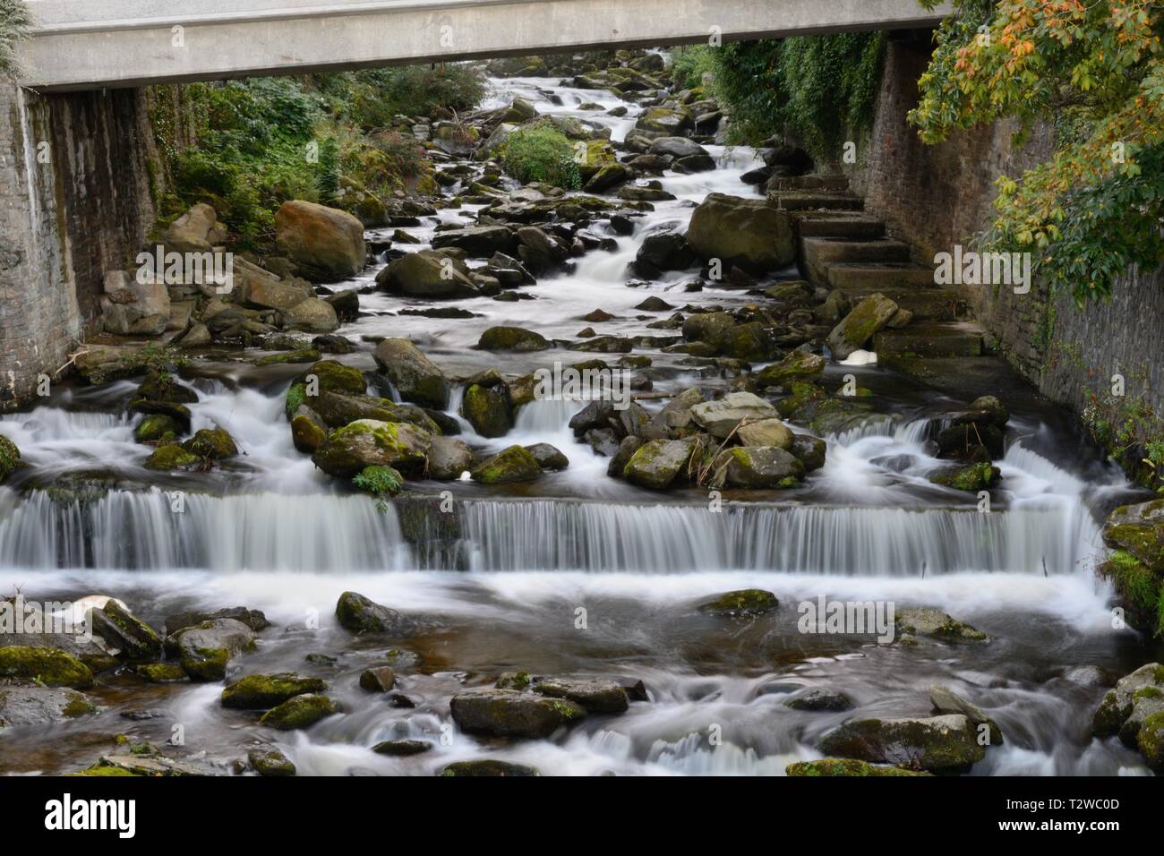 Water flowing under the bridge at Lynmouth in Devon Stock Photo