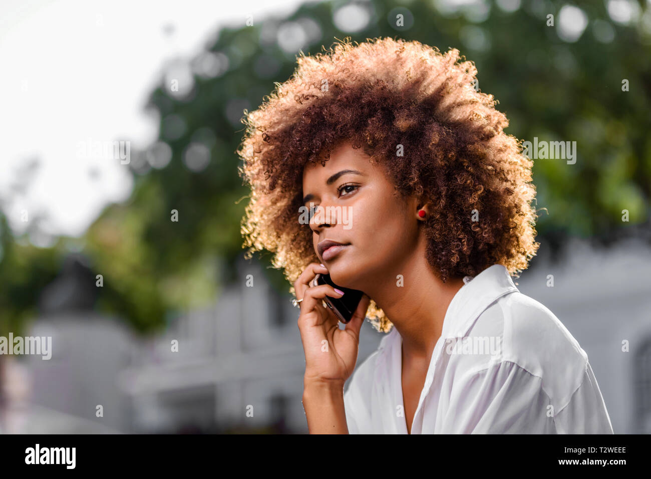 Outdoor portrait of a Young black African American young woman speaking ...