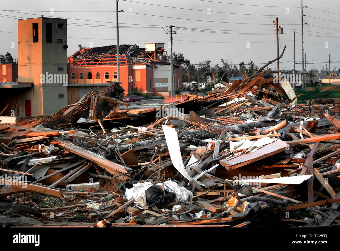 A home, destroyed by the April 27 tornado, stands in front of a heavily