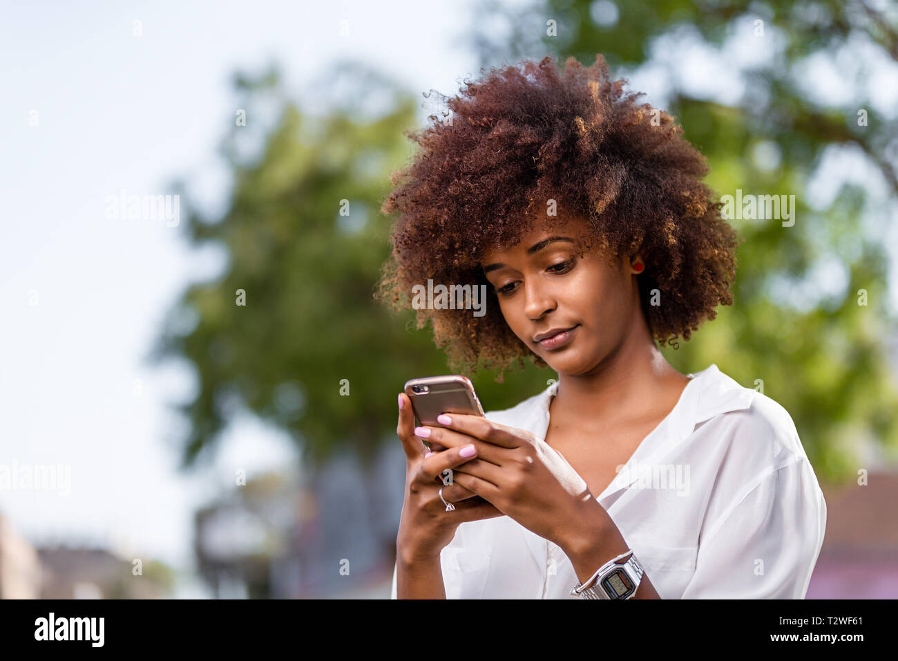 Outdoor portrait of a Young black African American young woman speaking ...