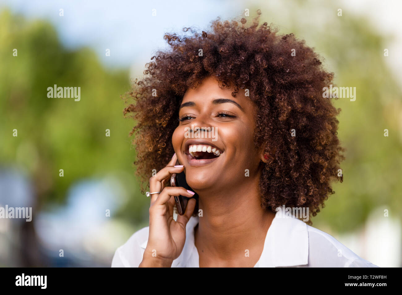 Outdoor portrait of a Young black African American young woman speaking ...