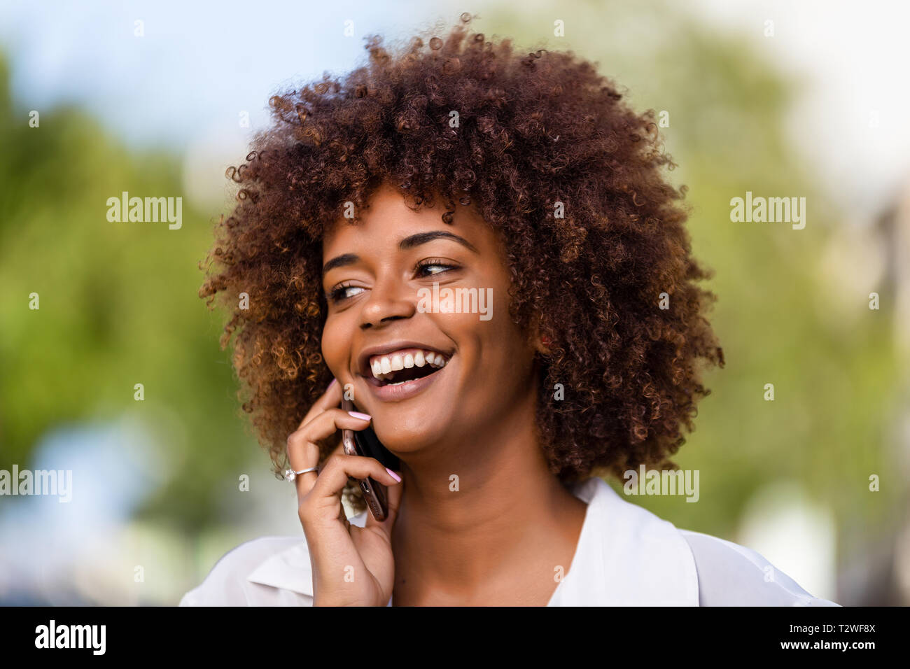 Outdoor portrait of a Young black African American young woman speaking ...