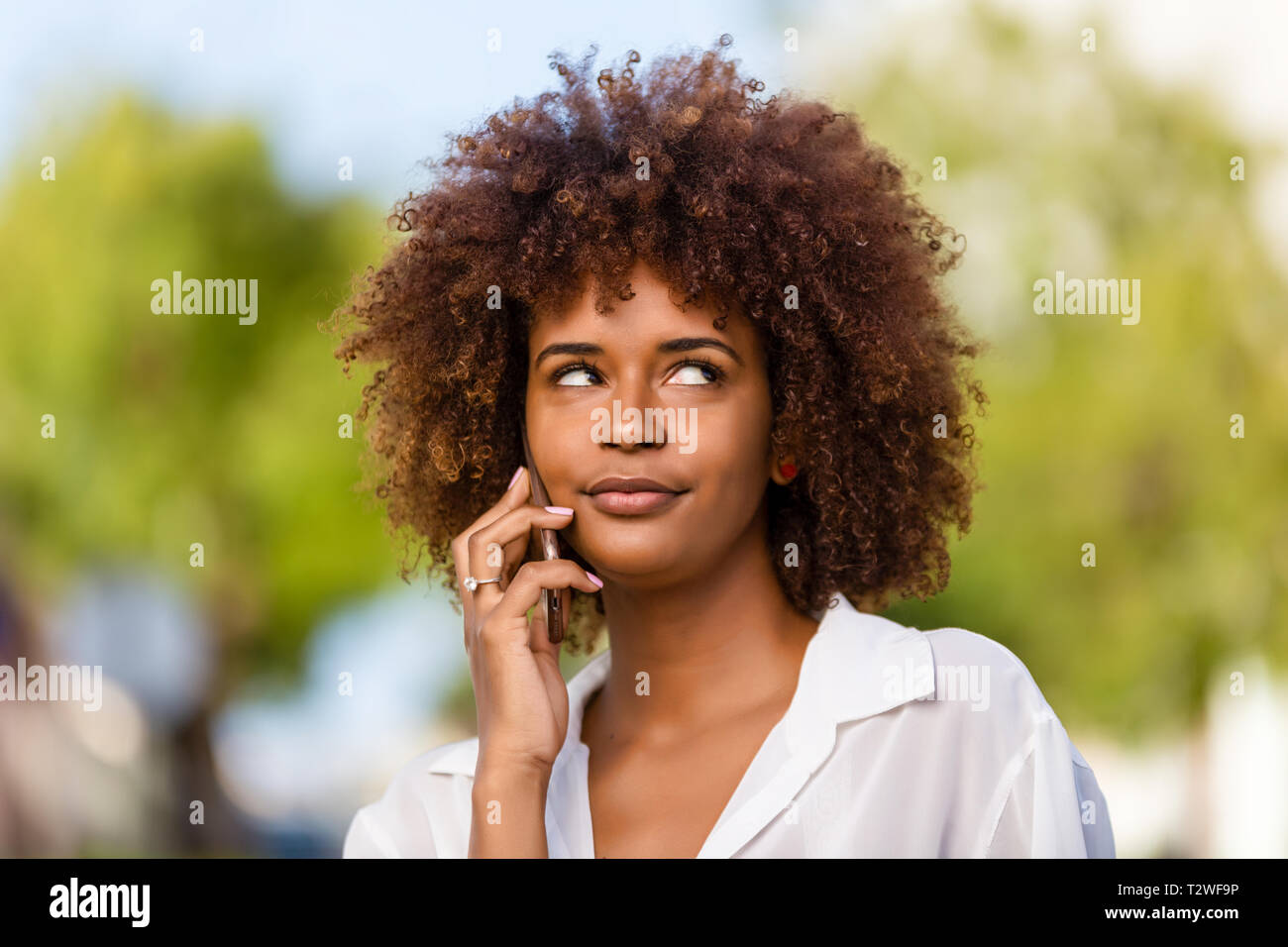 Outdoor portrait of a Young black African American young woman speaking ...