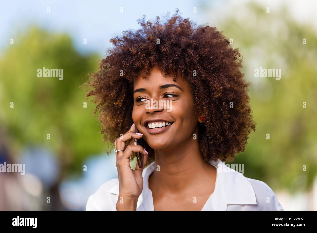 Outdoor portrait of a Young black African American young woman speaking ...