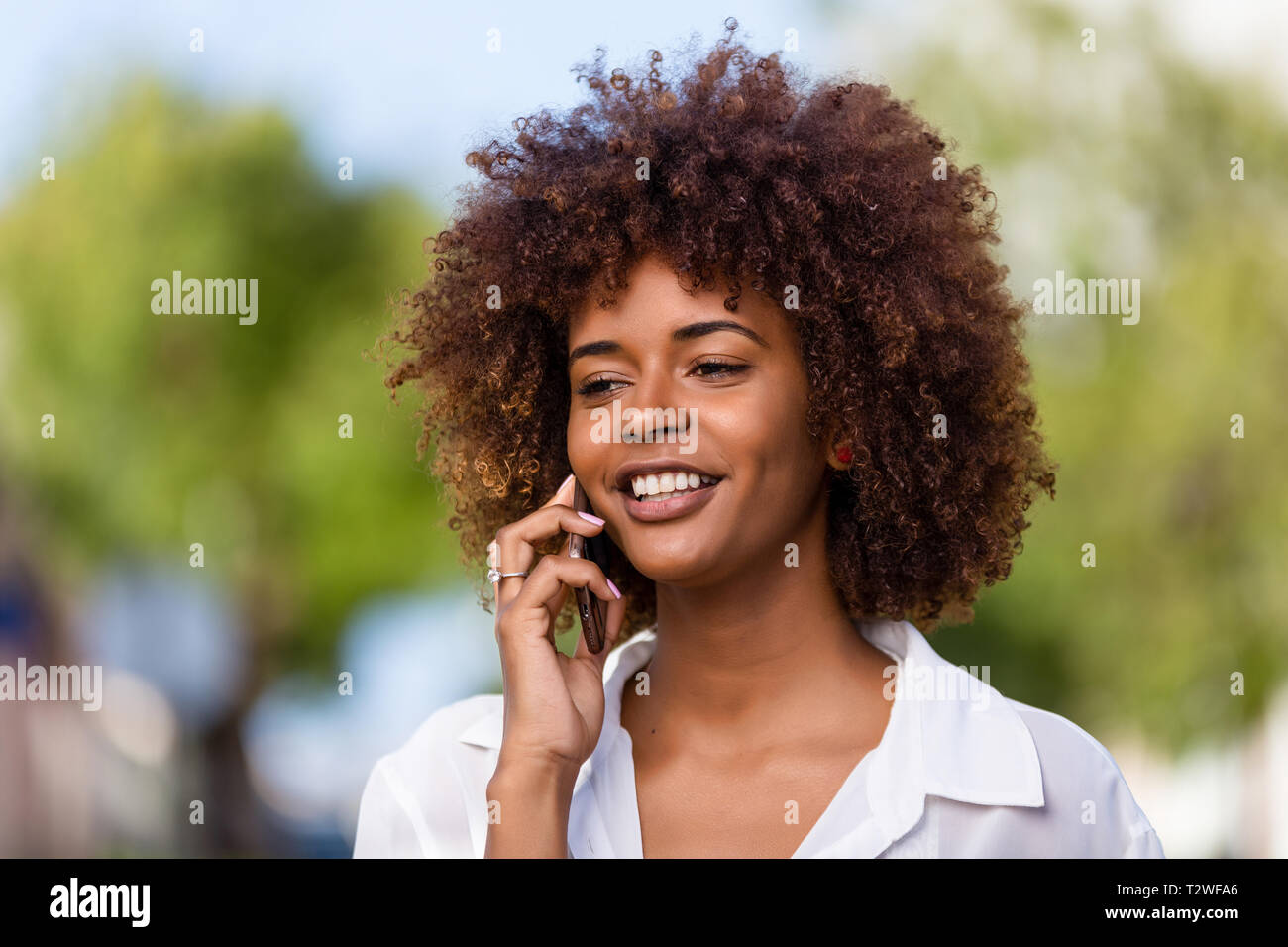 Outdoor portrait of a Young black African American young woman speaking ...