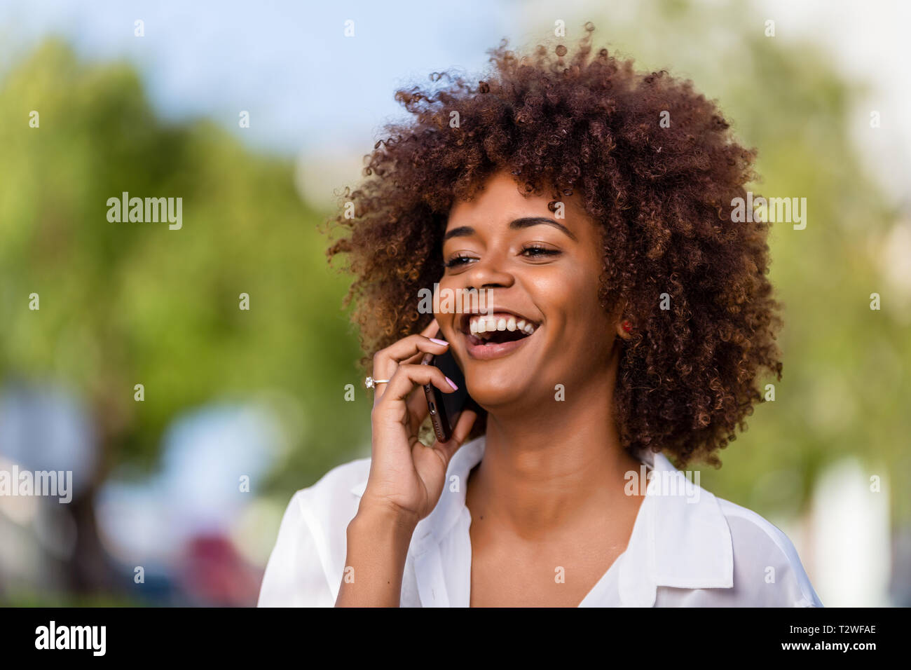 Outdoor portrait of a Young black African American young woman speaking ...