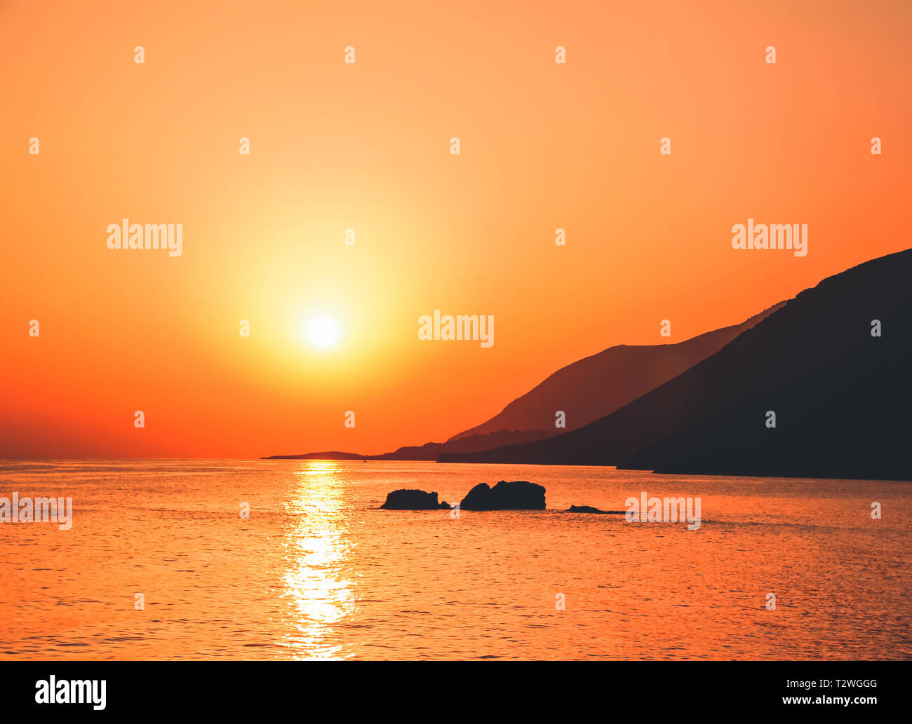 Beautiful sunset by the shores of Crete Island. Greece. Summer holiday trip. Stock Photo