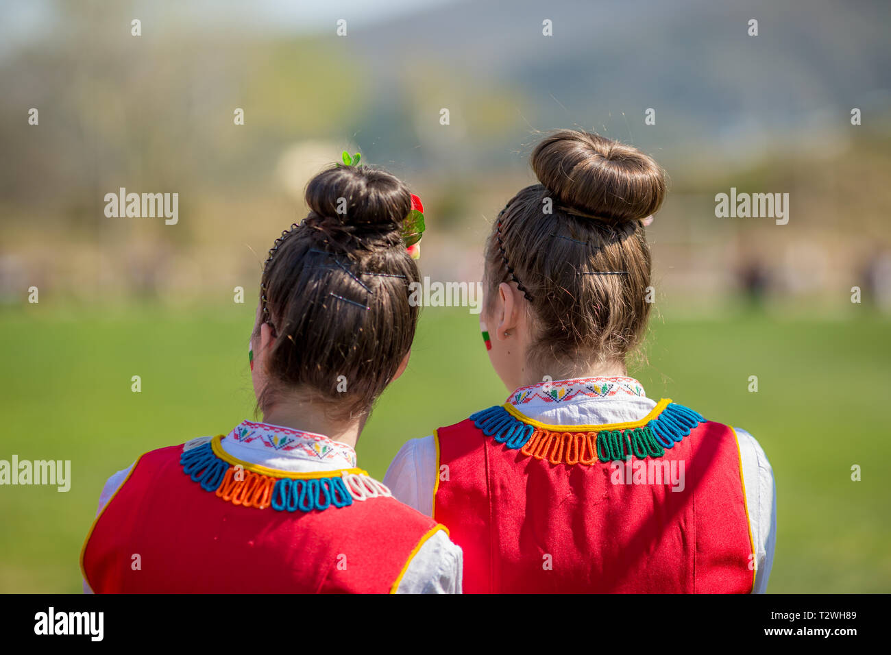 VARVARA, BULGARIA - MARCH 24, 2019: Moment from National Festival Dervish Varvara presents traditions of Bulgarian Kuker Games. Two girls in folklore  Stock Photo