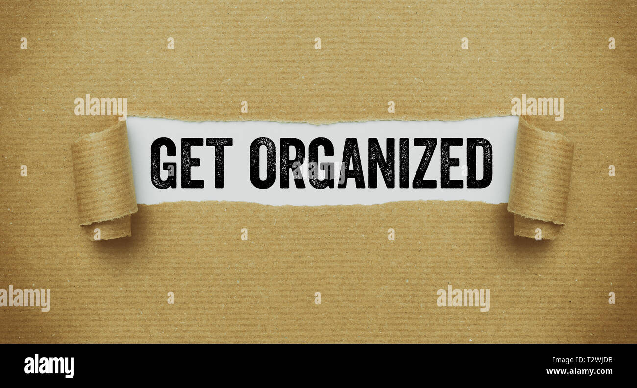 Torn Brown Paper Revealing The Words Get Organized Stock Photo Alamy