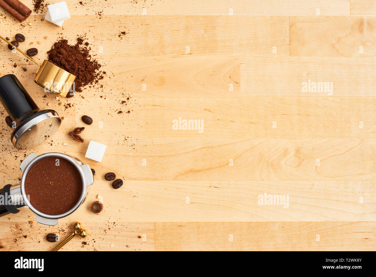 Assorted coffee beans, ground coffee, portafilter and tamper on wooden background. Top view of coffee background. Flat lay. Copy space for text. Baris Stock Photo