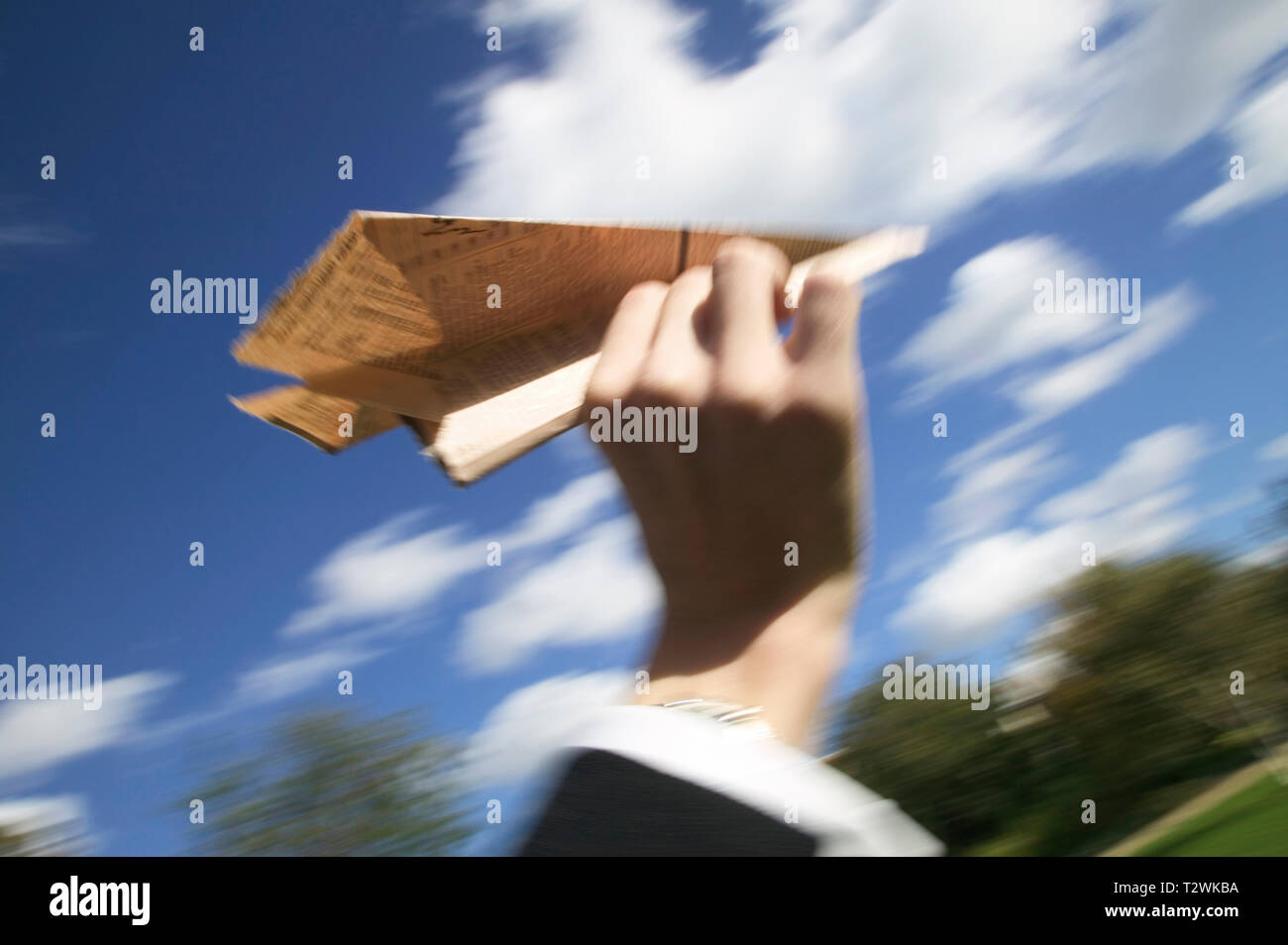 Low angle view of a caucasian businessman throwing a paper airplane Stock Photo