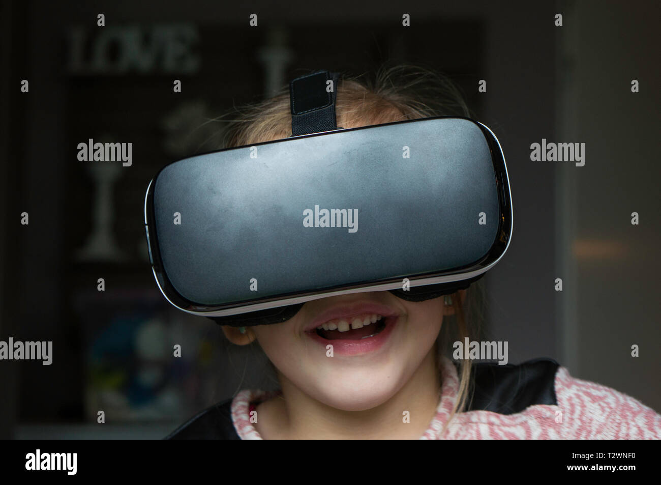 Child is using a vr headset at home. And having fun Stock Photo