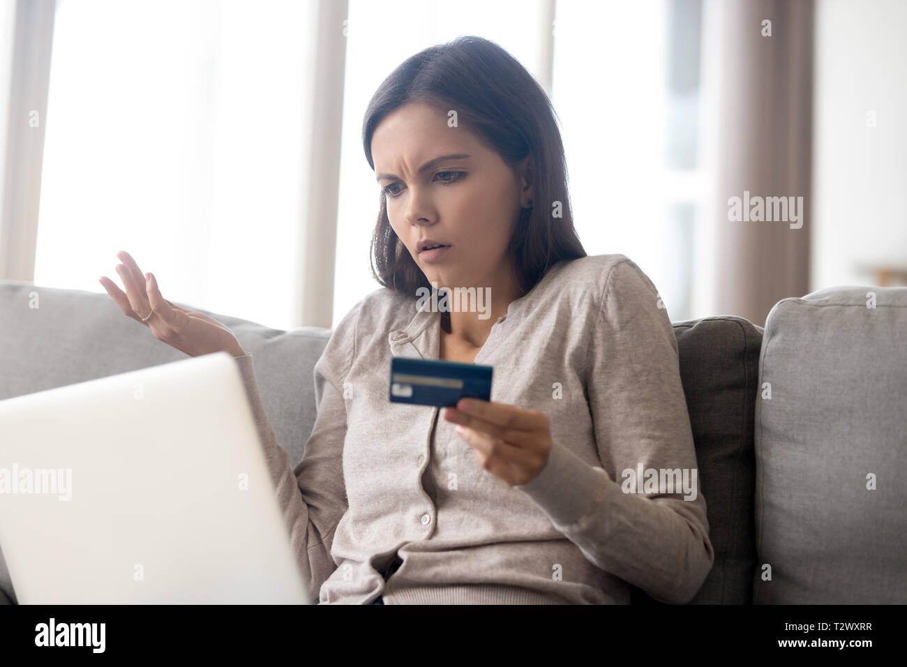 Woman using online banking having problem with blocked credit card Stock Photo