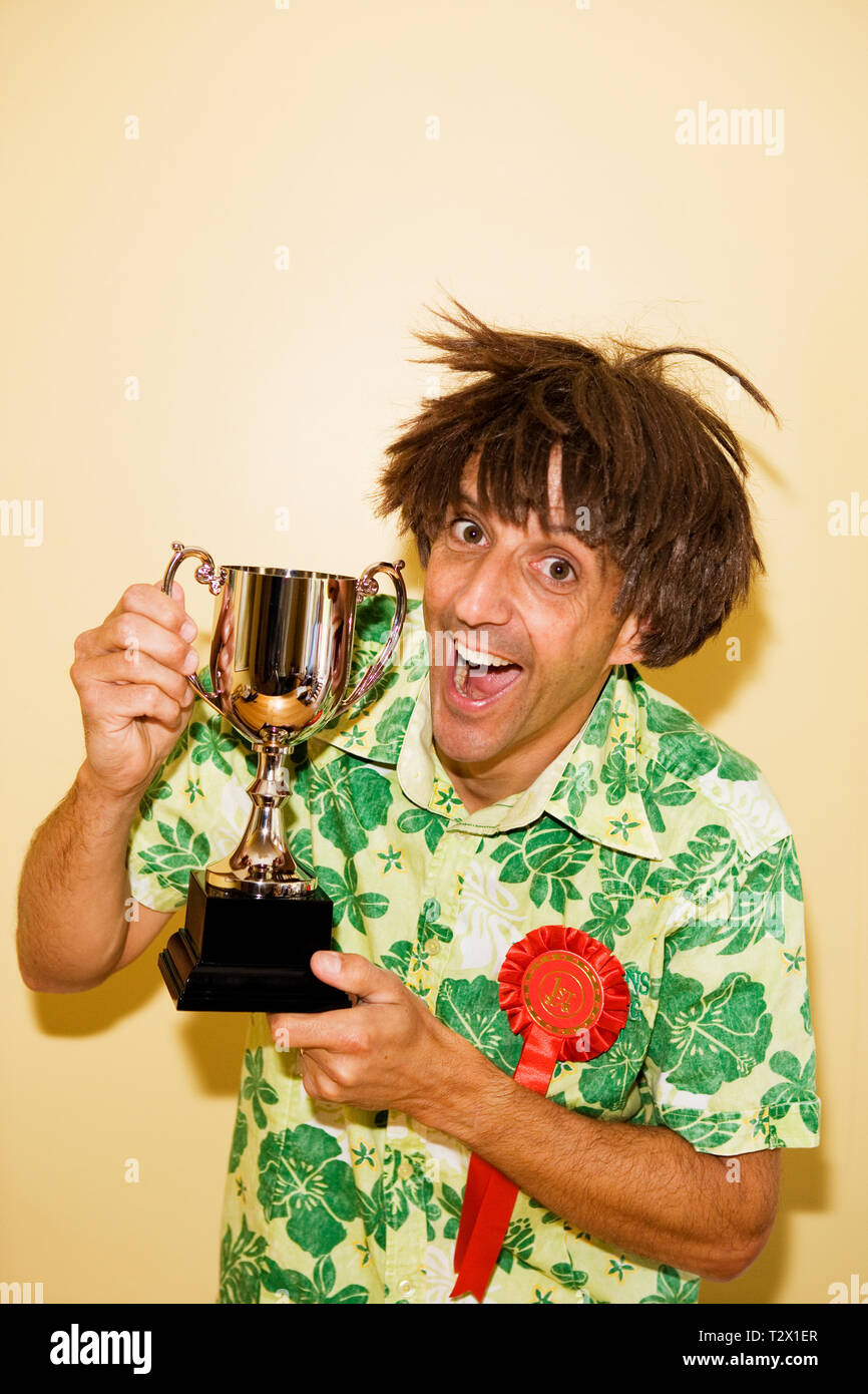 Middle aged caucasian man holding a trophy Stock Photo