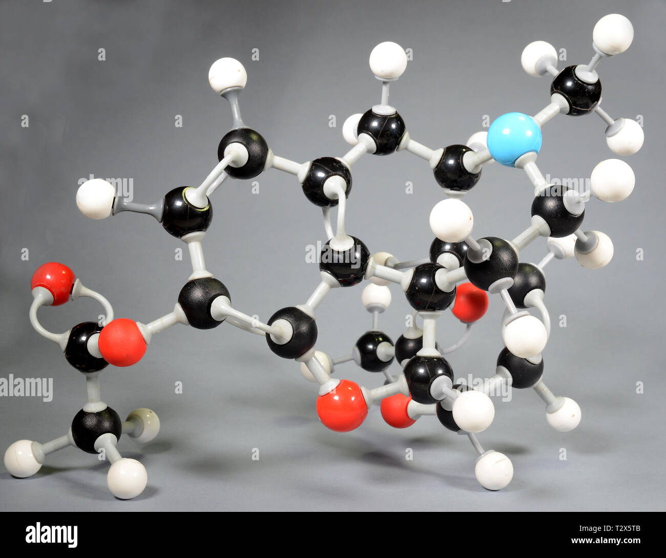 Molecule model of heroin (C12H22O11). Red is oxygen, black is carbon, blue is nirogen and white is hydrogen. Stock Photo