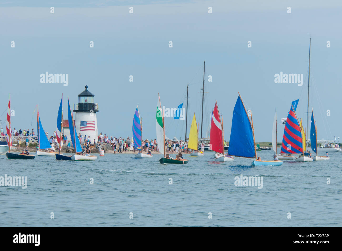 Rainbow Fleet paraded in front of Brant Point lighthouse Stock Photo