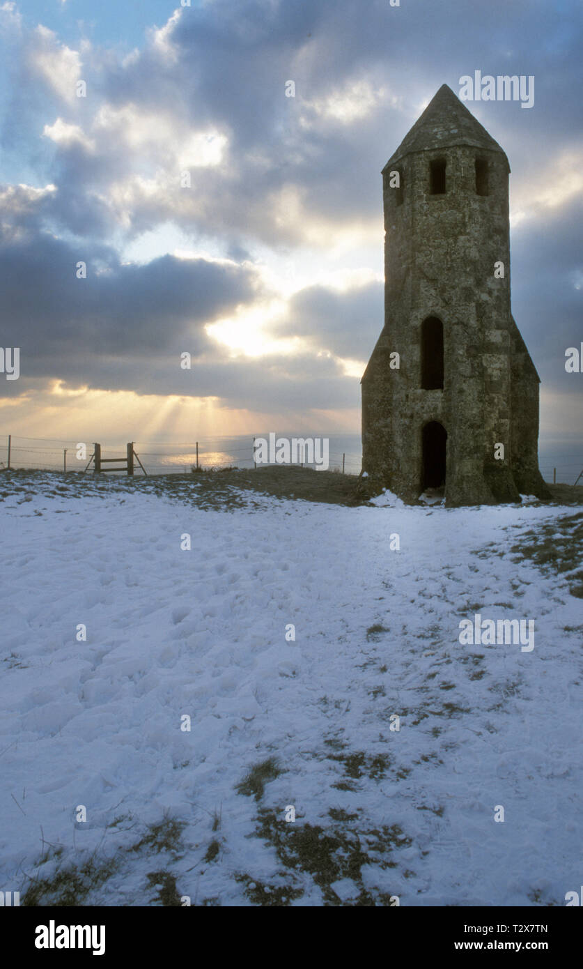 St Catherine's 14th century lighthouse in snow, St Catherine's Down, Chale, Isle of Wight, England Stock Photo