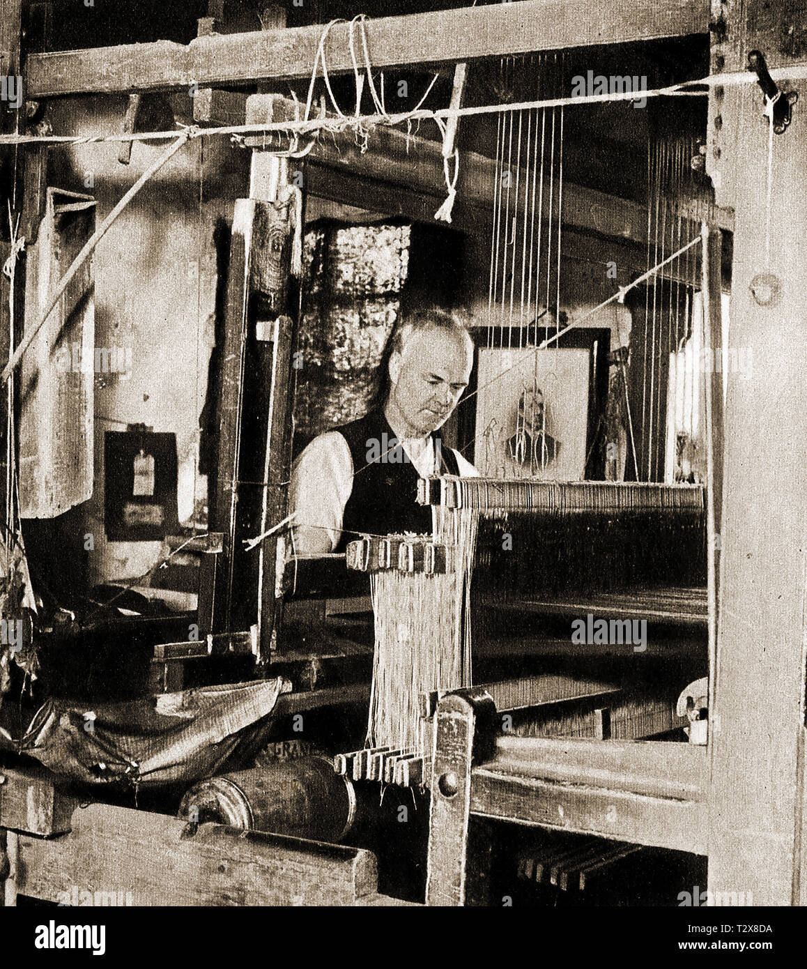 A vintage photograph of a Scottish village  (Kilbarchan) kilt weaver manufacturing kilts, a now defunct village trade -The village name means 'Cell of St. Barchan' Stock Photo