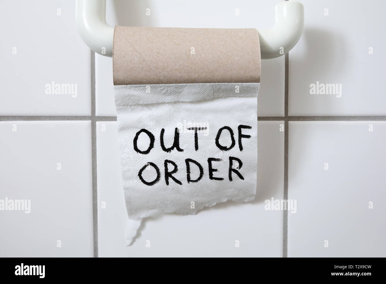 Written Text Out Of Order Message On Toilet Paper Roll In Bathroom Stock Photo