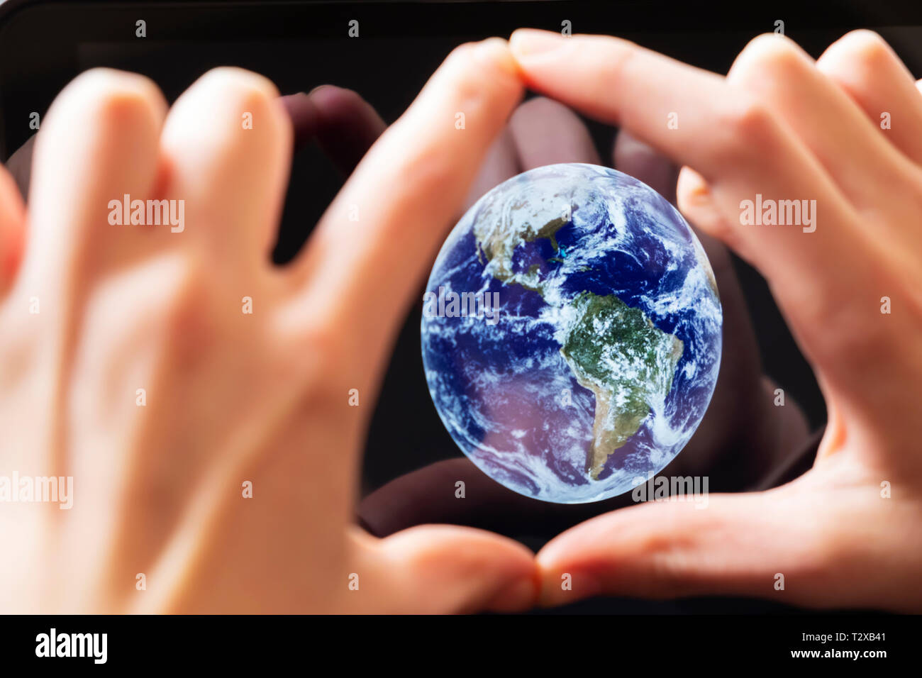 A caucasian girl framing the earth in his hands Stock Photo