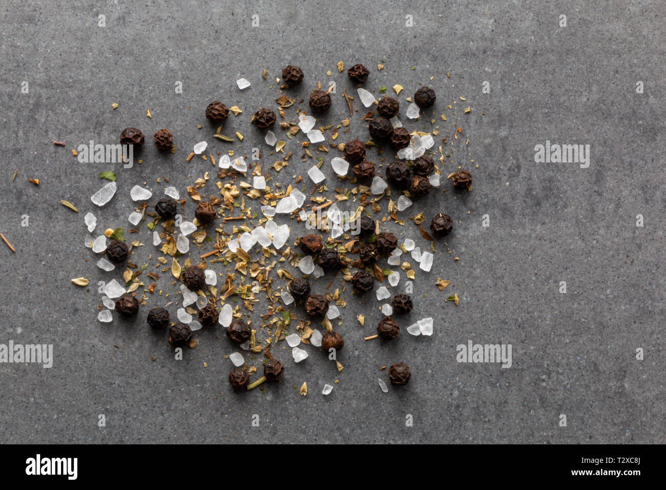 salt black pepper and herbs on gray background with copy space Stock Photo