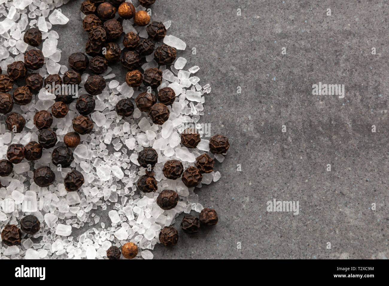 salt and black pepper on gray stone background Stock Photo