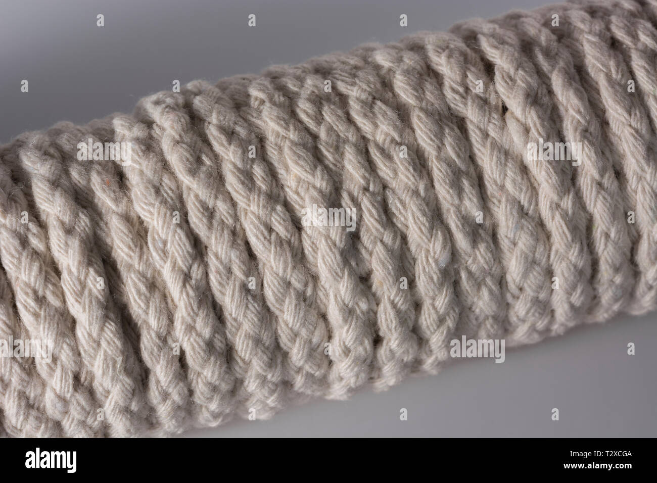 Close-up of a hank of natural multi-strand cotton cord - used for clotheslines and other jobs. Metaphor 'given enough rope'. Stock Photo