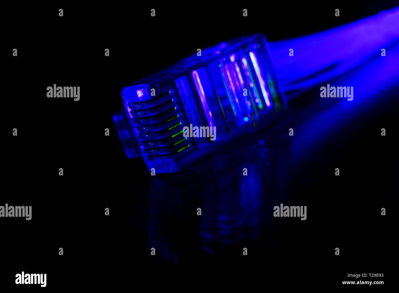 Network connection plug with fiber optics cable isolated on black background Stock Photo