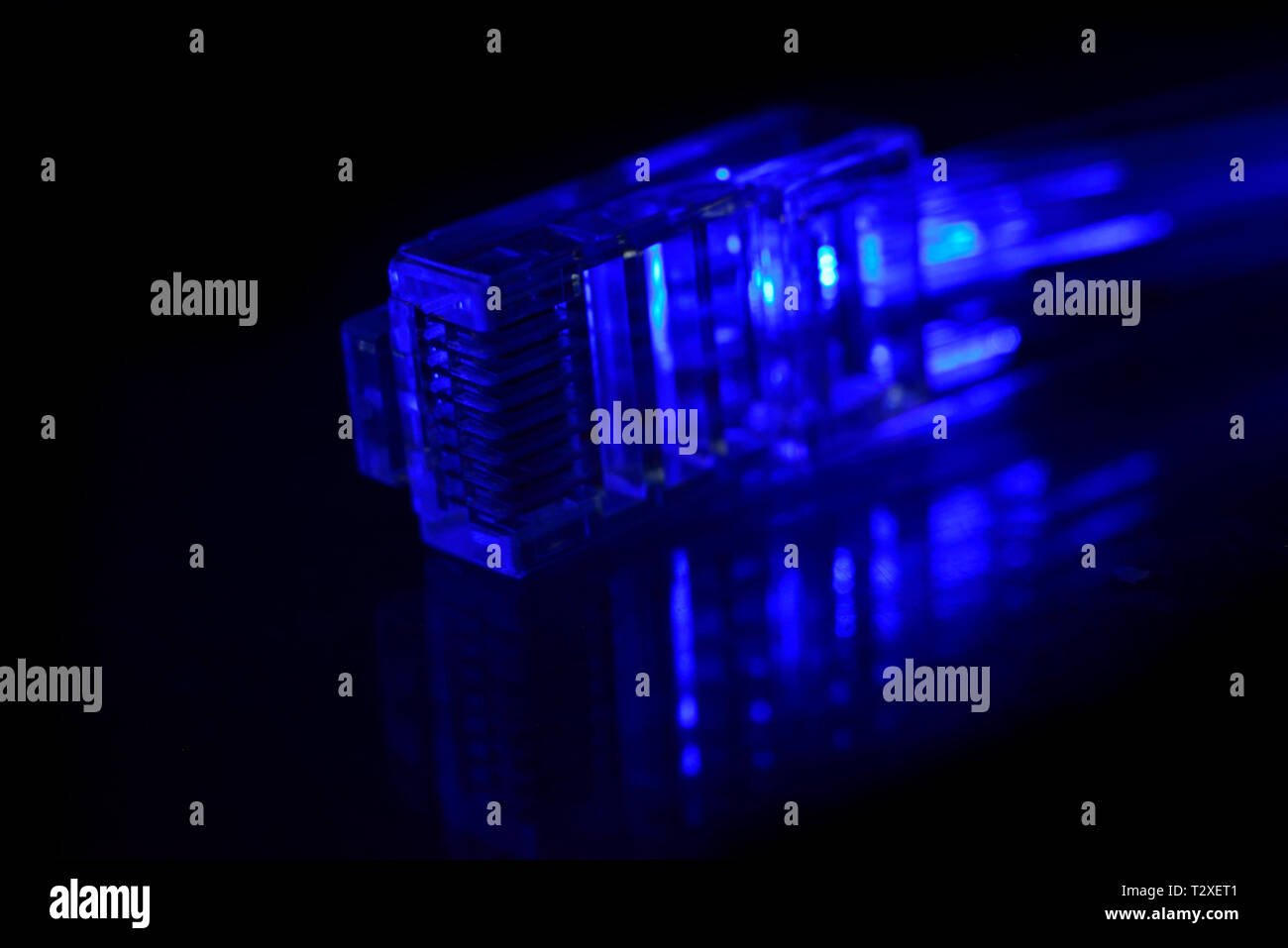 Network connection plug with fiber optics cable isolated on black background Stock Photo