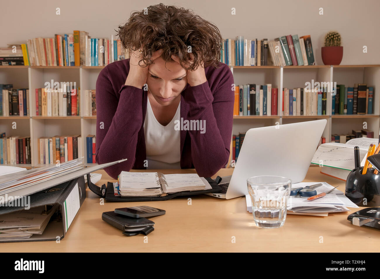 Stressed young woman working at home Stock Photo