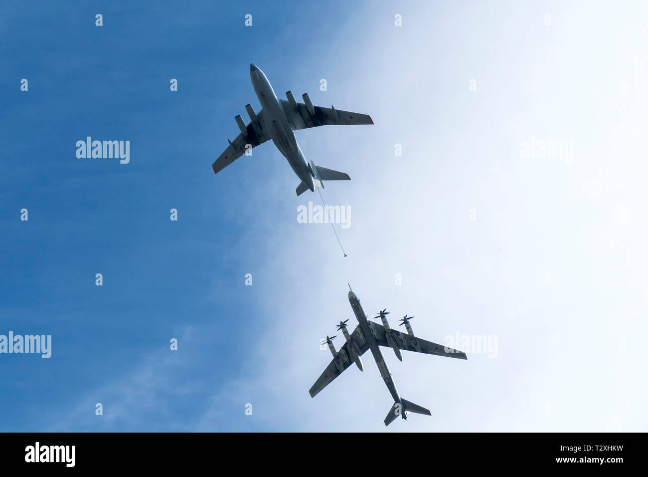 Air tanker Ilyushin IL-78 and Strategic bomber Tu-95 'Bear' simulate in-flight refueling at Parade of Victory in World War II. Russian planes Stock Photo