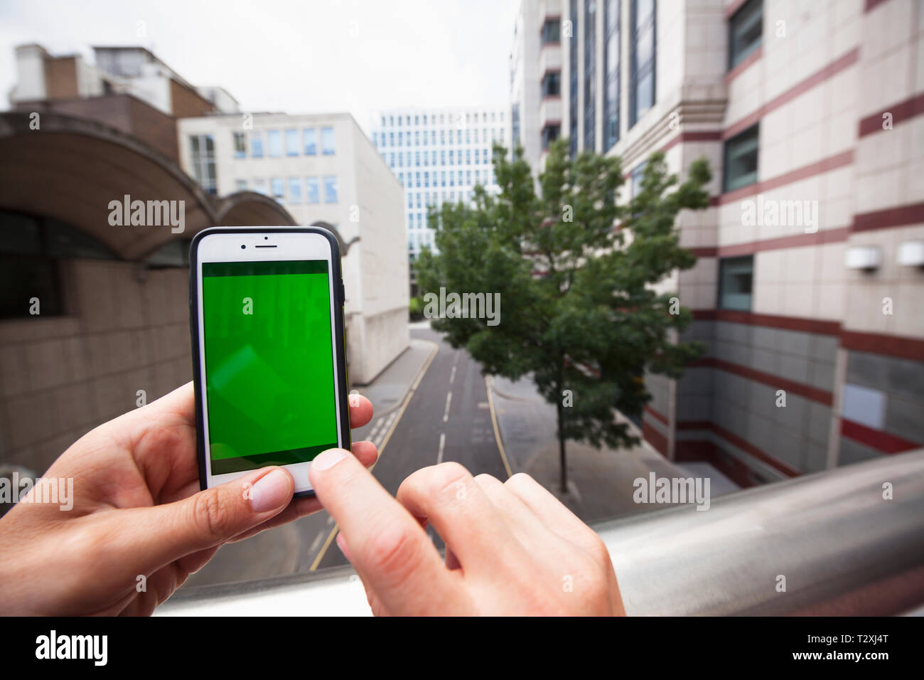 Personal perspective of a man using a smartphone with a green screen Stock Photo