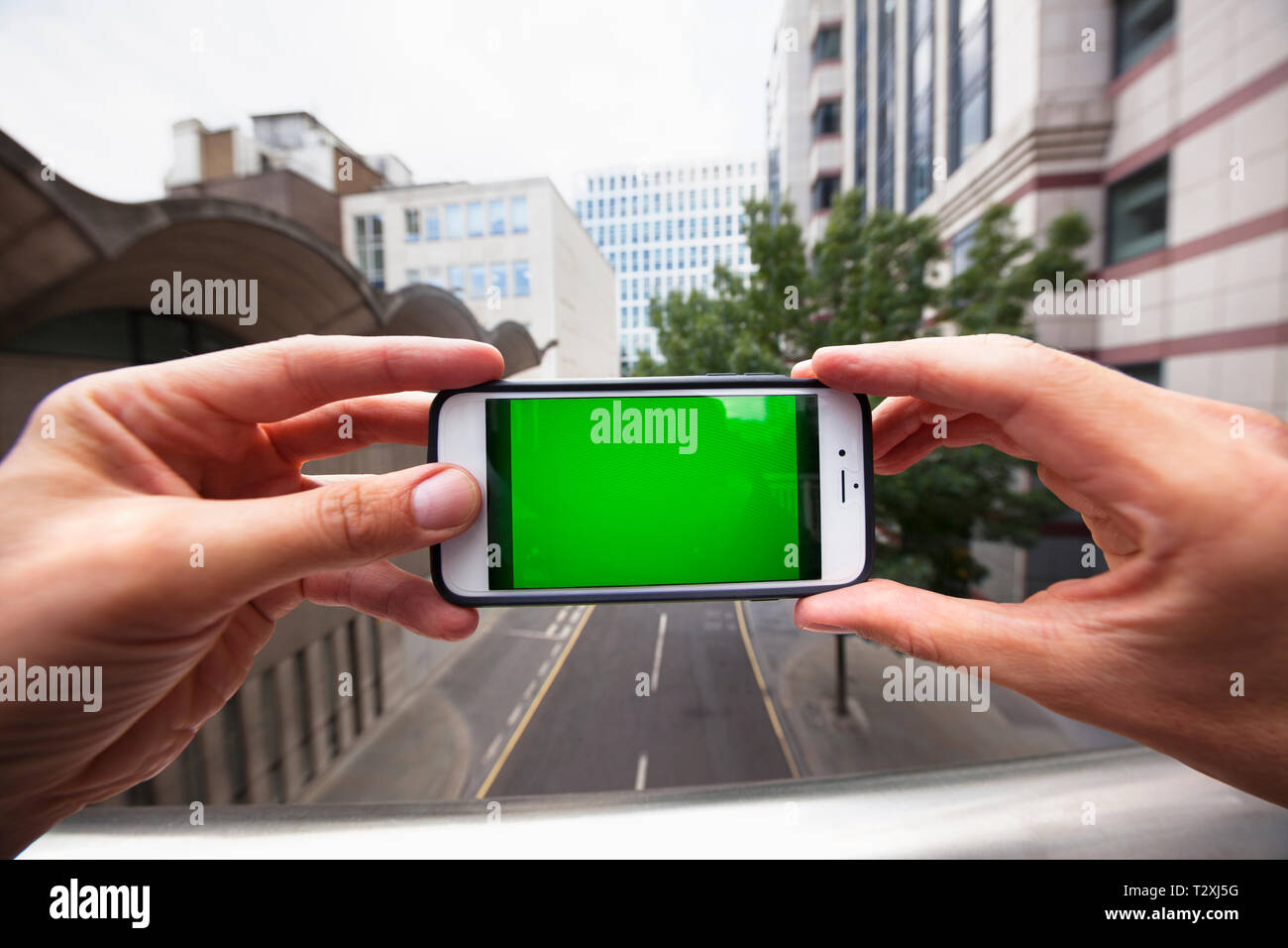 Using Phone Ref Perspective Personal perspective of a man using a smartphone with a green screen ...