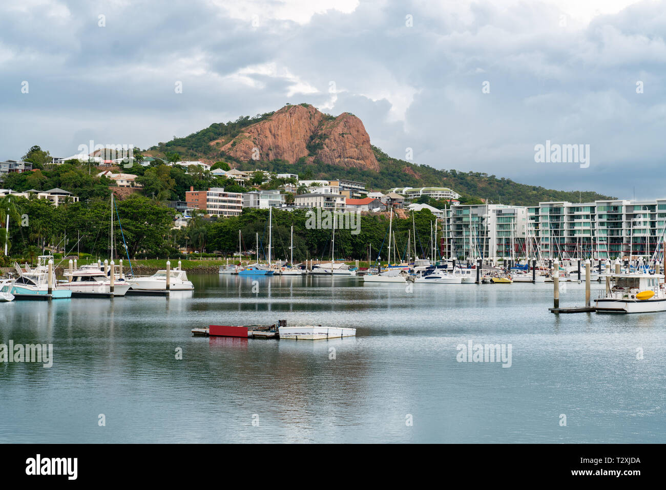 Boats moored in the Townsville Marina with iconic Castle Hill in the background Stock Photo