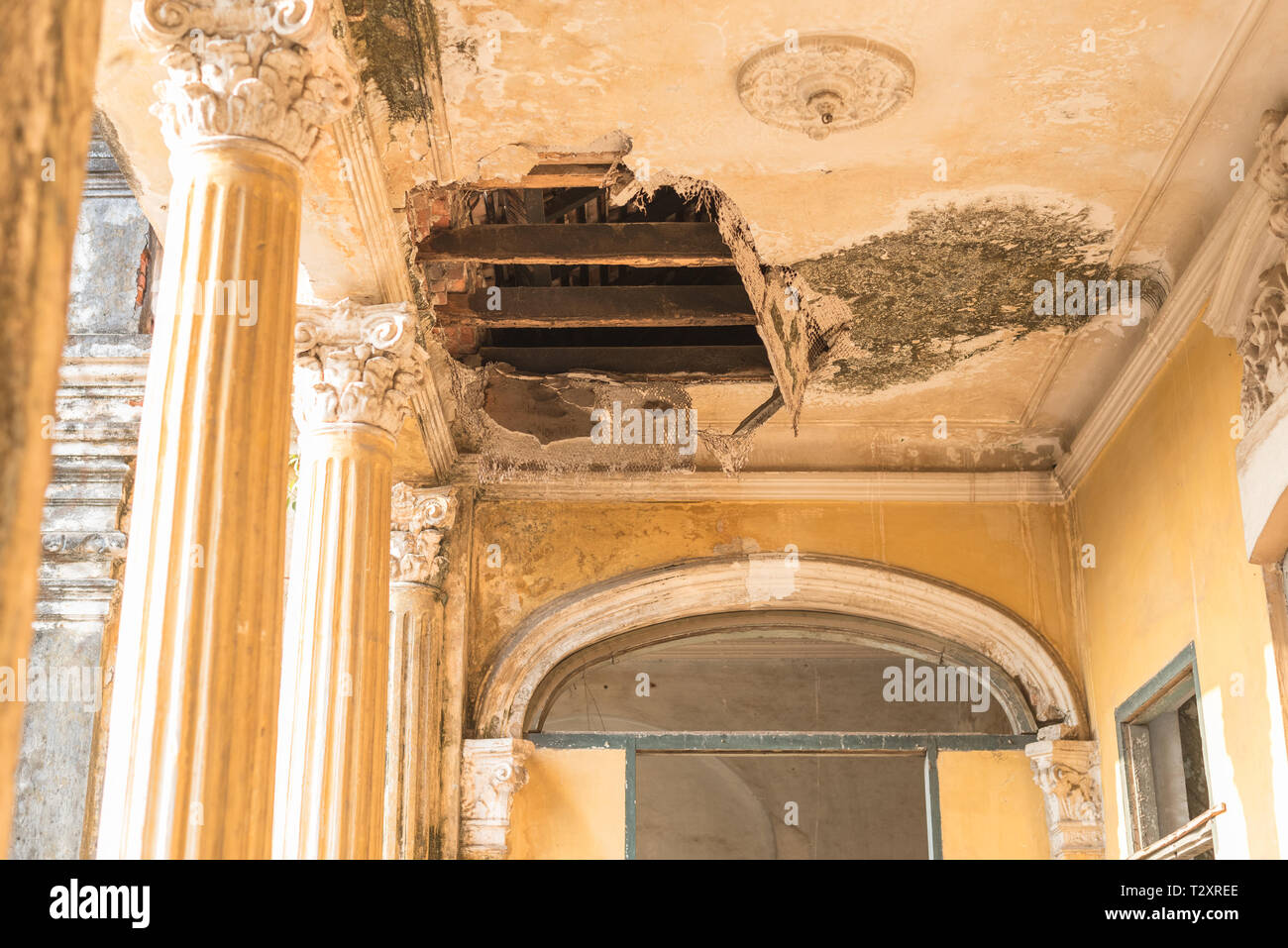 Hole in the plaster ceiling in the Mansion or Villa Bodega, a half-ruined colonial-era building (1910-1920s) in Phnom Penh city center, Cambodia. Stock Photo