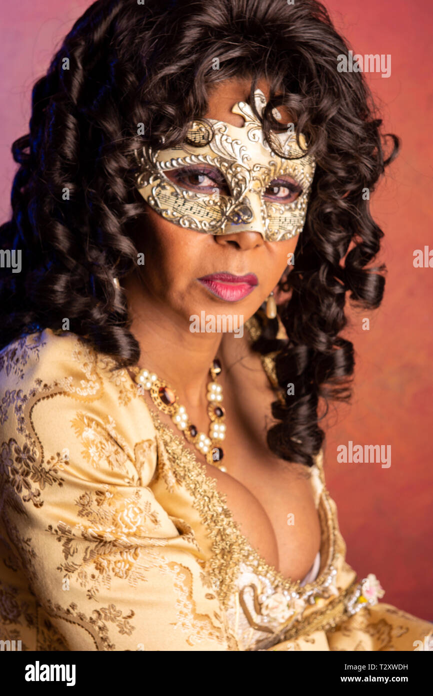 A middle aged, Puerto Rican, woman at a masquerade party. Stock Photo