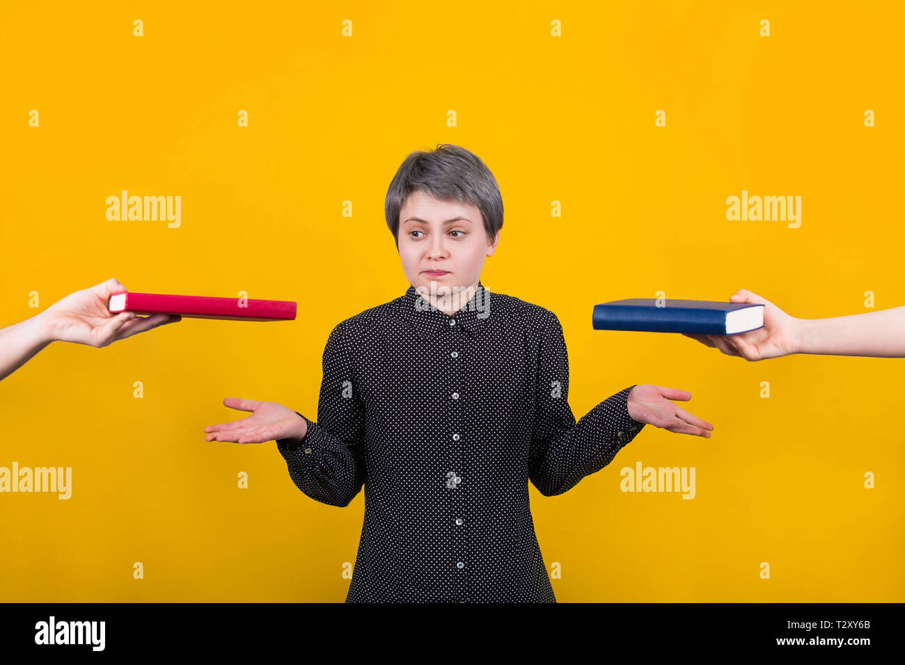 Puzzled young woman student balancing hands thinking what to choose ...