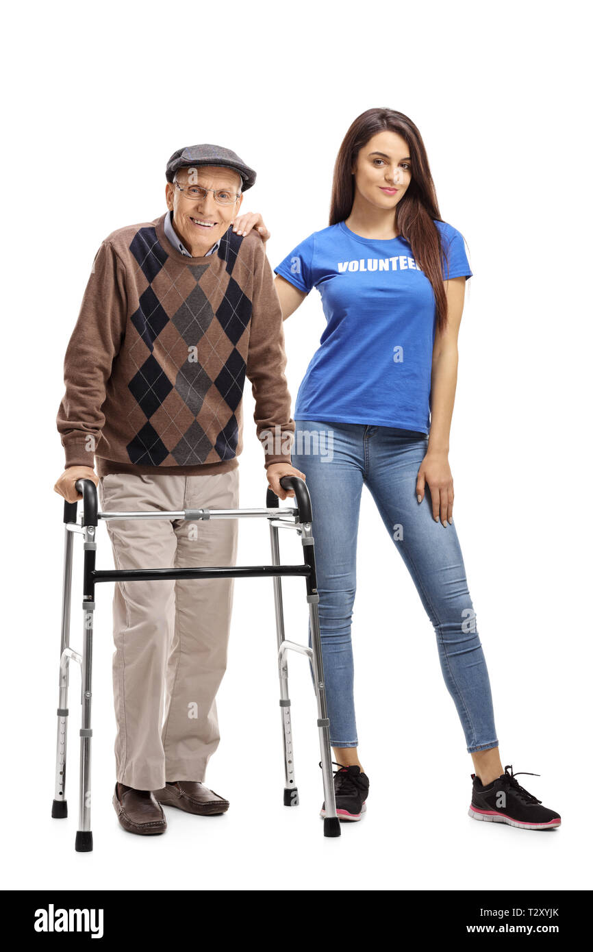 Full length portrait of a senior man with a walker and a young female volunteer isolated on white background Stock Photo