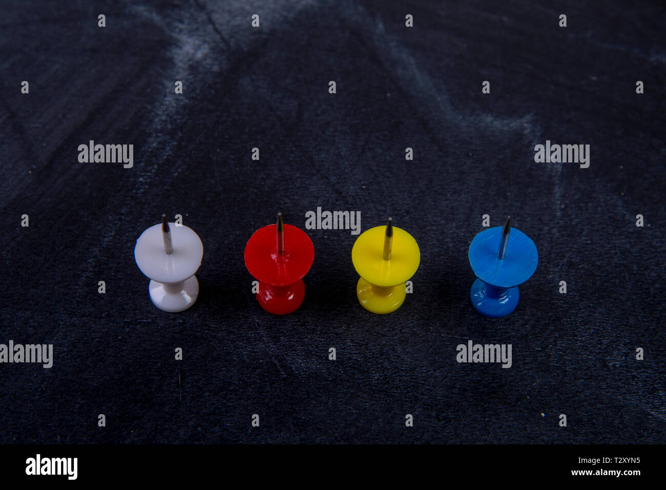 different coloured pins on a board Stock Photo