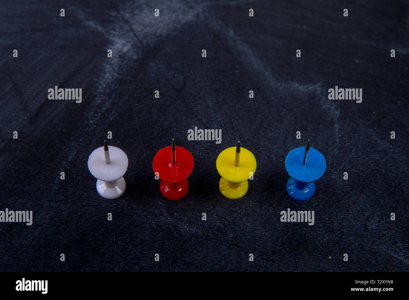 different coloured pins on a board Stock Photo