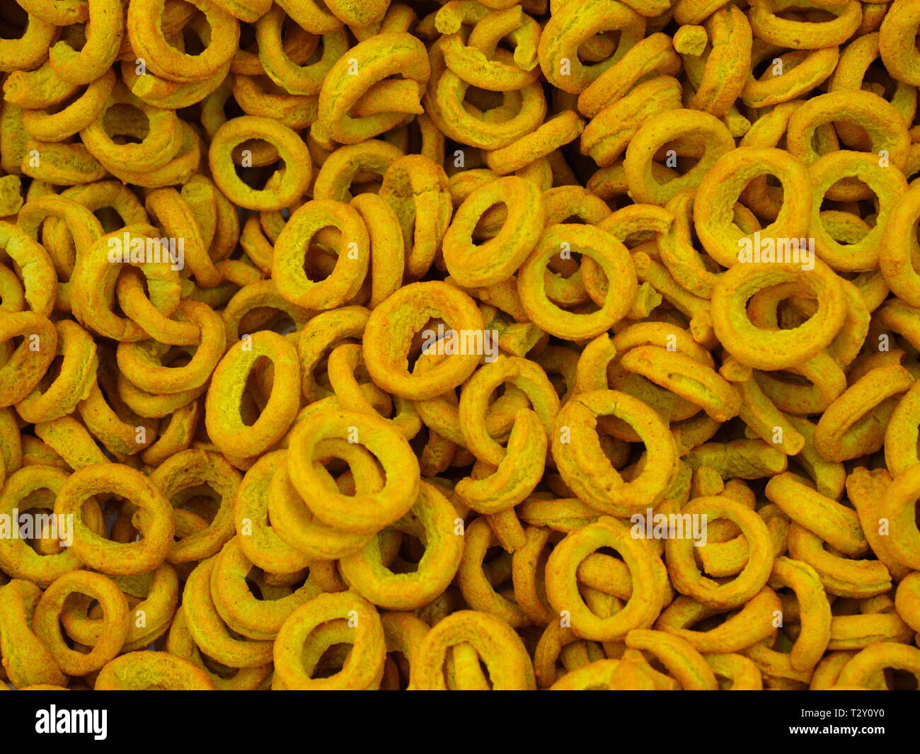 ring chips made of roasted chickpea powder. top view chips background