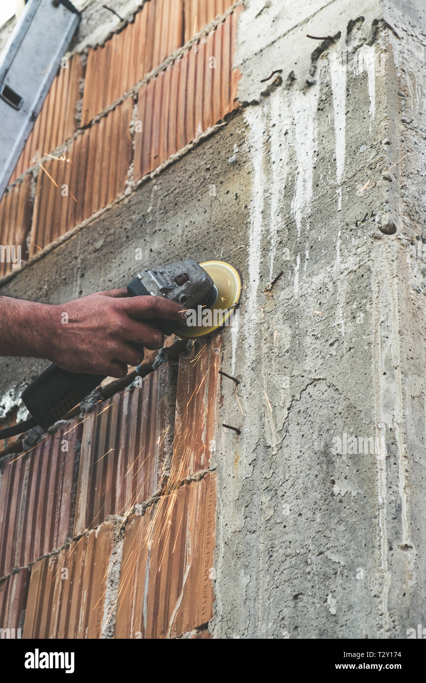 Worker cutting rebar form the concrete with the grinder Stock Photo Alamy